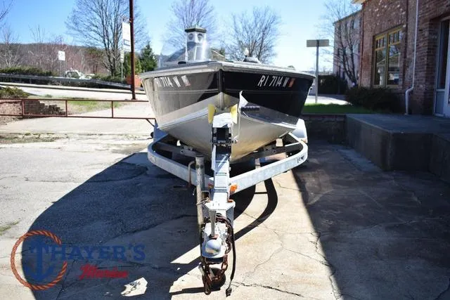 Slide: The Image of 2015 Lund 1800 Alaskan boat on trailer, parked outdoors near a building. - 7