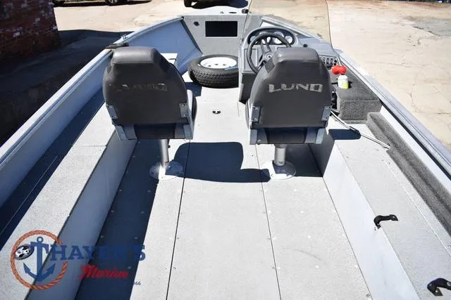Slide: The Image of 2015 Lund 1800 Alaskan boat interior with two seats and steering console. - 9