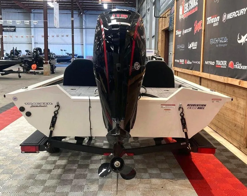 Slide: The Image of 2025 Tracker Pro Team™ 190 boat displayed indoors, featuring a powerful outboard motor. - 4