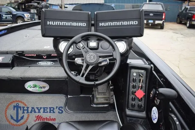 Slide: The Image of 2019 Phoenix Bass Boats 920 dashboard with dual Humminbird displays and steering wheel. - 13