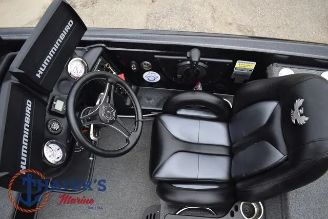 Slide: The Image of 2019 Phoenix Bass Boats 920 cockpit with steering wheel, gauges, and black leather seat. - 14
