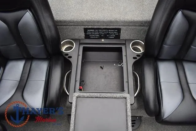 Slide: The Image of 2019 Phoenix Bass Boats 920 interior with black seats and center storage compartment. - 18