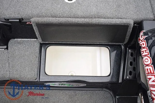 Slide: The Image of 2019 Phoenix Bass Boats 920 storage compartment with open lid, featuring Thayer's Marine logo. - 20