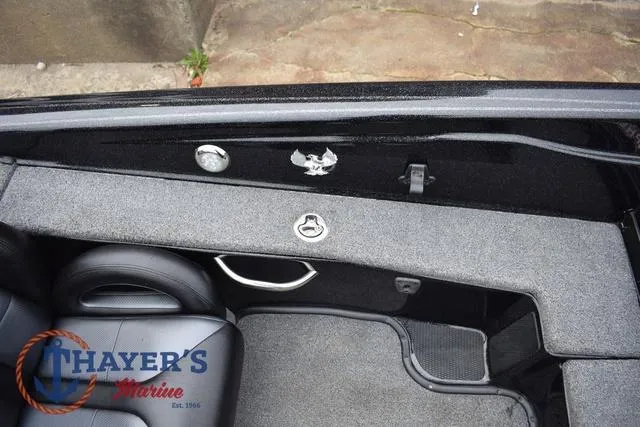 Slide: The Image of 2019 Phoenix Bass Boats 920 interior with Thayer's Marine logo, featuring seating and storage. - 23