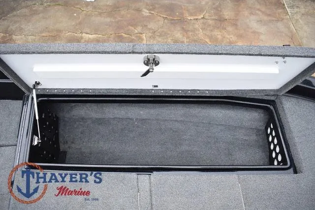 Slide: The Image of 2019 Phoenix Bass Boats 920 storage compartment, open lid, Thayer's Marine logo visible. - 27