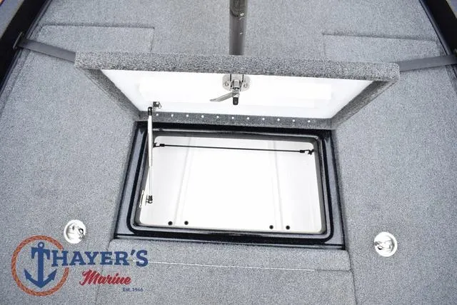 Slide: The Image of 2019 Phoenix Bass Boats 920 storage compartment, open lid, Thayer's Marine logo visible. - 29