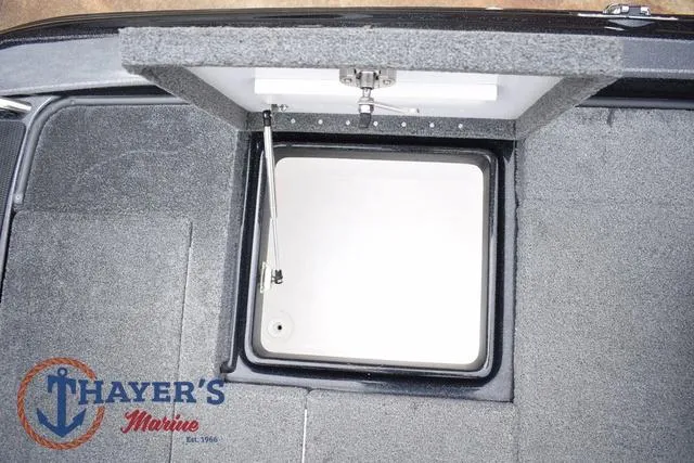 Slide: The Image of 2019 Phoenix Bass Boats 920 storage compartment, open lid, Thayer's Marine logo visible. - 36