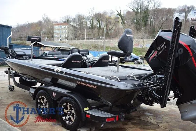 Slide: The Image of 2019 Phoenix Bass Boats 920, black, parked outdoors with trees and buildings in the background. - 5
