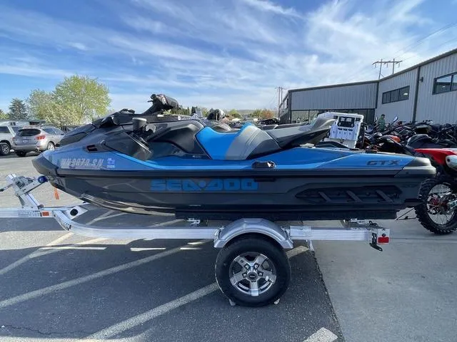 Slide: The Image of 2018 Sea-Doo Waverunner GTX on trailer, parked outdoors under a clear sky. - 3