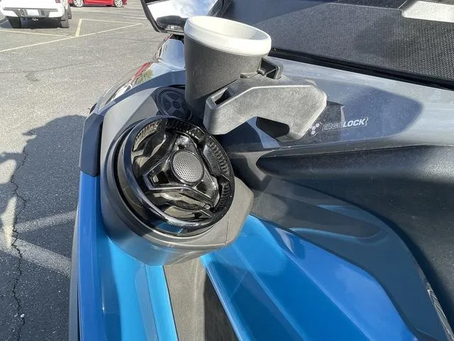 Slide: The Image of 2018 Sea-Doo GTX Waverunner with cup holder and speaker, parked in a lot. - 7