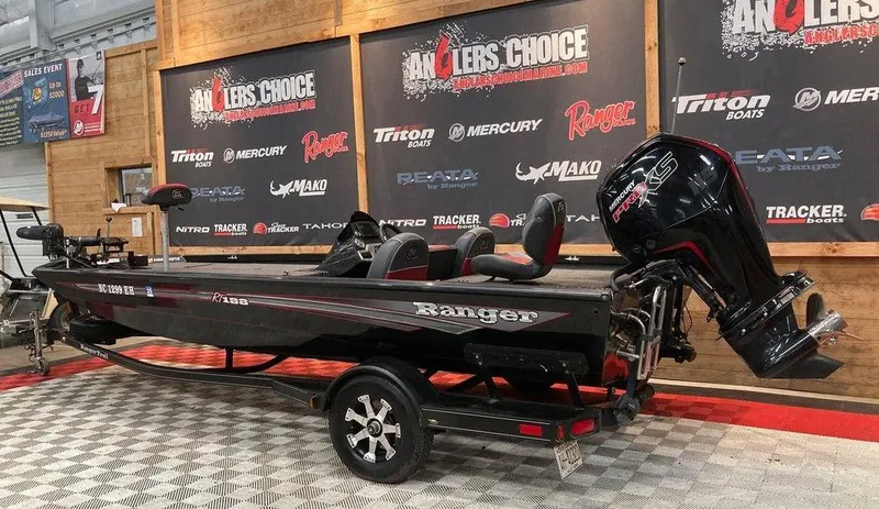 Slide: The Image of 2018 Ranger RT188 boat on display with Mercury engine, in showroom setting. - 2