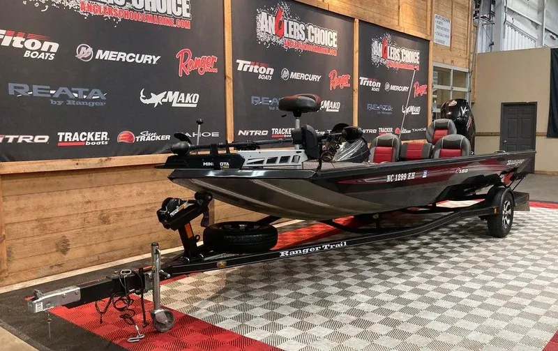 Slide: The Image of 2018 Ranger RT188 fishing boat on display in showroom with promotional banners. - 4