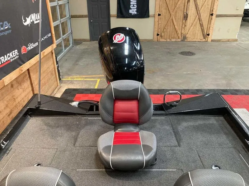 Slide: The Image of 2018 Ranger RT188 boat interior with red and gray seating, displayed in a showroom. - 8