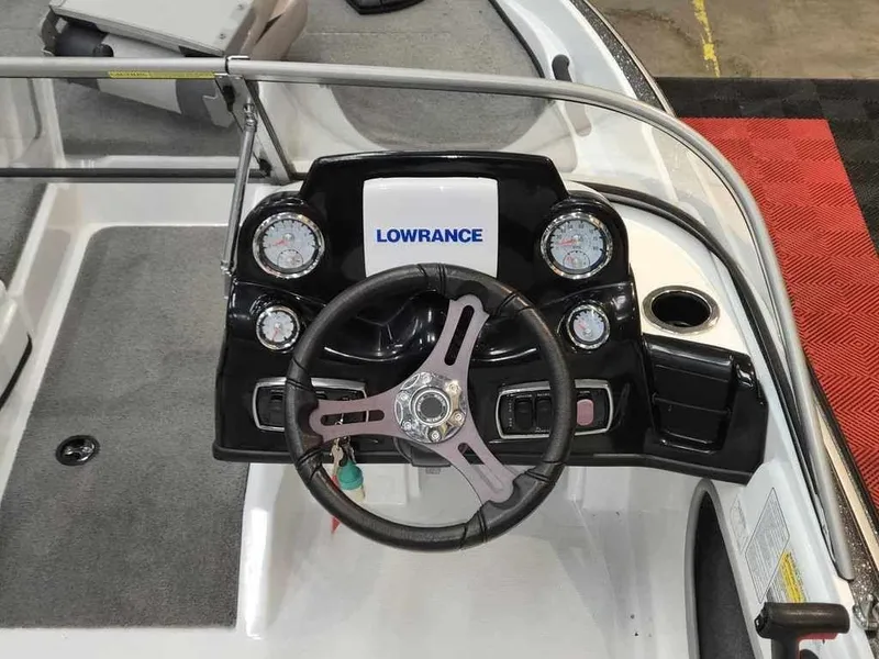 Slide: The Image of 2018 Nitro Z19 Sport boat dashboard with Lowrance electronics and steering wheel. - 6