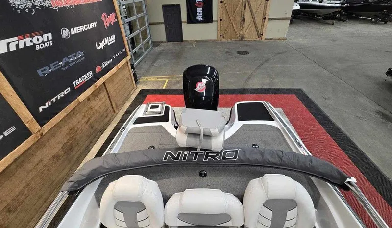 Slide: The Image of 2018 Nitro Z19 Sport boat in showroom, featuring sleek design and comfortable seating. - 8