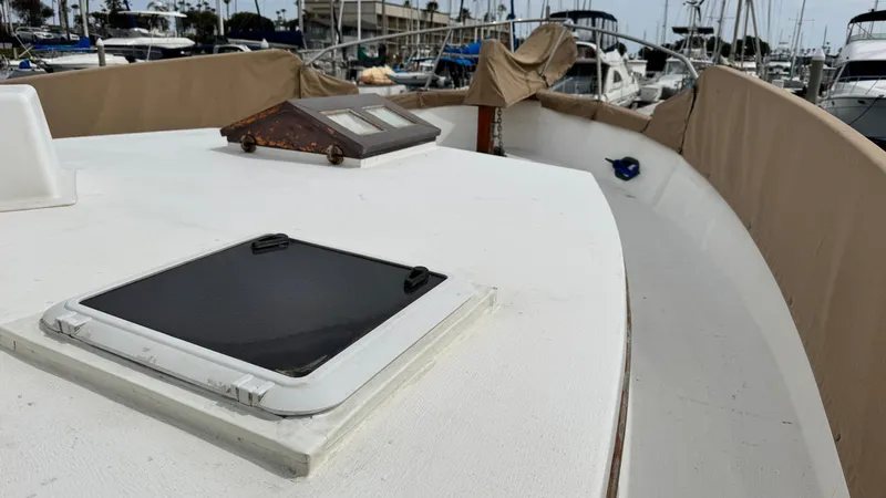 Slide: The Image of 1977 Marine Trader Europa boat deck with hatches, docked in a marina. - 12