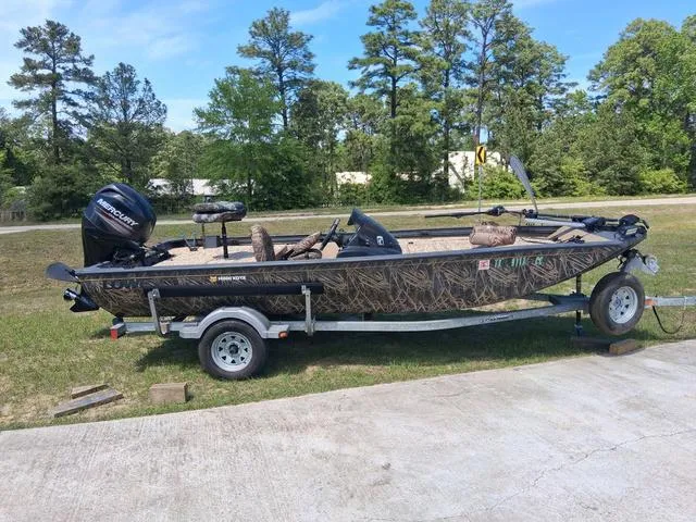 Slide: The Image of 2014 Lowe Stinger ST175 Camo boat on trailer, parked outdoors. - 1