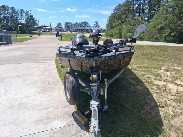 Slide: The Image of 2014 Lowe Stinger ST175 Camo boat on trailer, parked outdoors on a sunny day. - 3