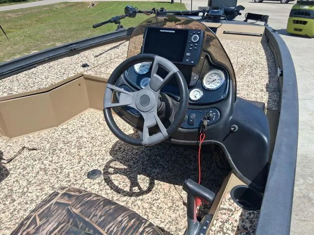 Slide: The Image of 2014 Lowe Stinger ST175 Camo boat dashboard with steering wheel and gauges. - 6