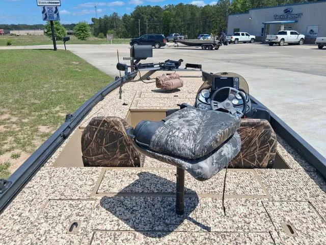 Slide: The Image of 2014 Lowe Stinger ST175 Camo boat with camo seats and dashboard, parked outdoors. - 7