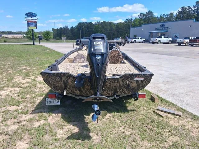 Slide: The Image of 2014 Lowe Stinger ST175 Camo boat with 60 HP motor, parked outdoors. - 9