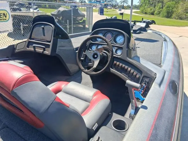 Slide: The Image of 2004 Skeeter TZX200 boat interior with steering wheel, gauges, and red-gray seating. - 5