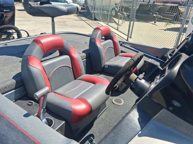 Slide: The Image of 2004 Skeeter TZX200 boat interior with red and gray seats, steering wheel, and console. - 6