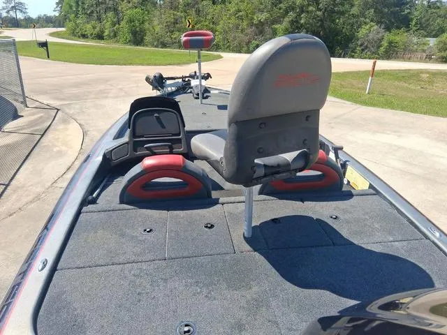 Slide: The Image of 2004 Skeeter TZX200 boat with gray and red seating, parked on a sunny day. - 7