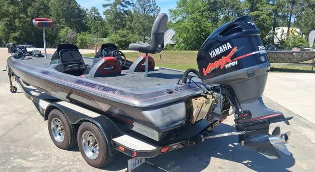 Slide: The Image of 2004 Skeeter TZX200 boat with Yamaha VMAX engine on a trailer, parked outdoors. - 8