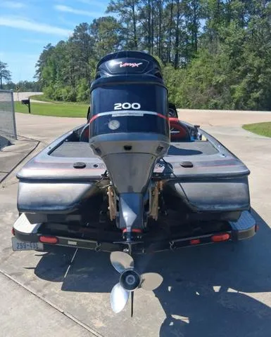 Slide: The Image of 2004 Skeeter TZX200 boat with powerful engine, parked outdoors on a sunny day. - 9