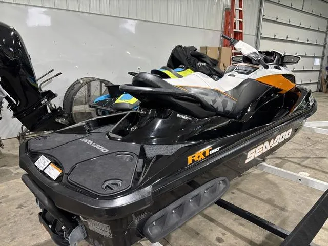 Slide: The Image of 2014 Sea-Doo RXT Waverunner in a garage, black and orange design. - 5