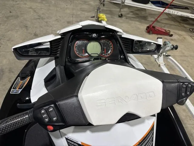 Slide: The Image of 2014 Sea-Doo Waverunner RXT dashboard with controls and display in a garage setting. - 6