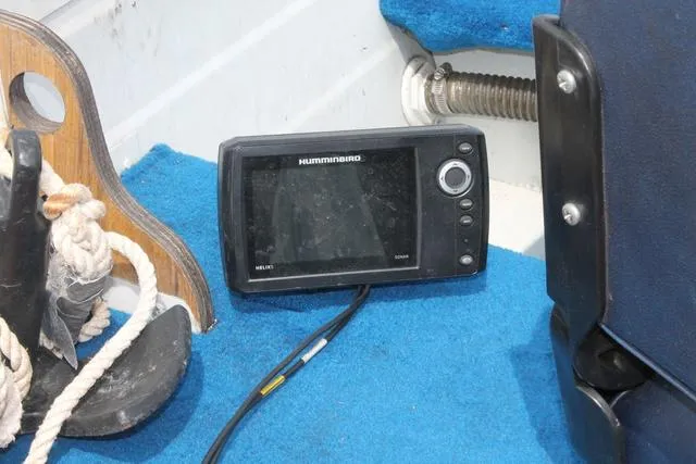 Slide: The Image of Fishfinder on blue carpeted deck of 1998 Smoker Craft BIG FISH boat. - 10