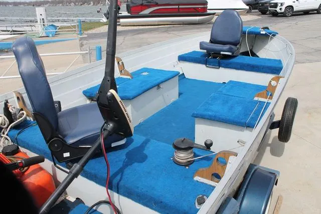 Slide: The Image of 1998 Smoker Craft BIG FISH boat with blue seating and fishing equipment. - 9