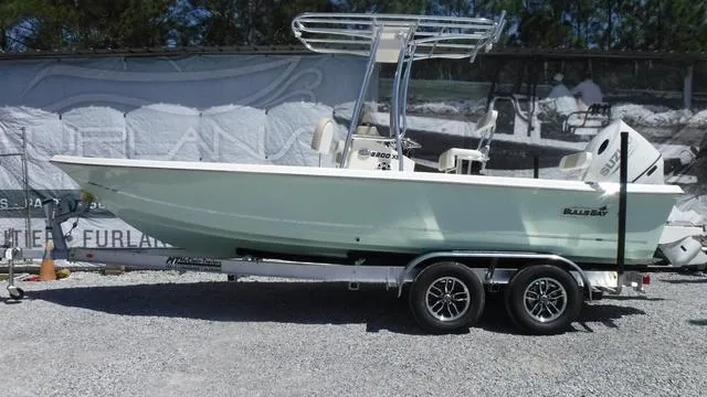 Slide: The Image of 2025 Bulls Bay 2200XS boat on trailer, parked outdoors. - 1