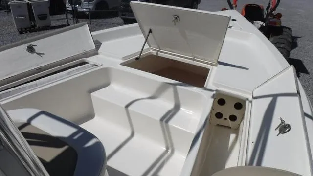 Slide: The Image of 2025 Bulls Bay 2200XS boat interior with open storage compartments and seating area. - 5