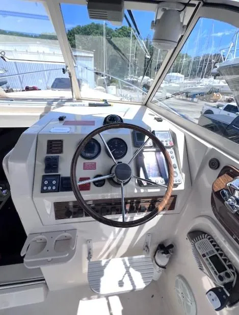 Slide: The Image of 2004 Mainship 30 Pilot Rum Runner helm with steering wheel and navigation instruments. - 10