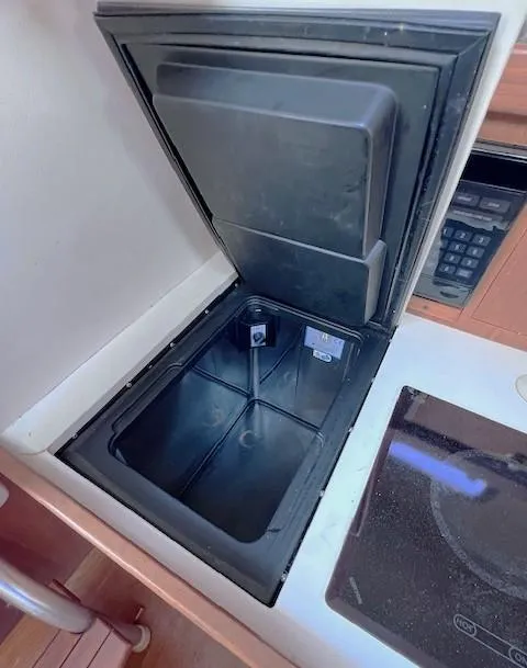 Slide: The Image of 2004 Mainship 30 Pilot Rum Runner boat interior with open storage compartment. - 19