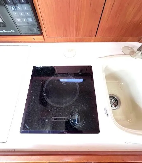 Slide: The Image of 2004 Mainship 30 Pilot Rum Runner kitchen with stove and sink. - 20