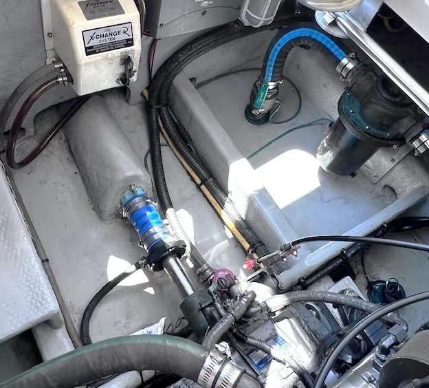 Slide: The Image of Engine compartment of a 2004 Mainship 30 Pilot Rum Runner boat, showing mechanical components. - 23