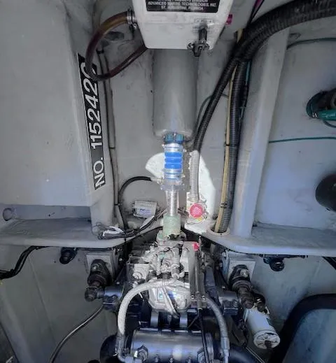 Slide: The Image of Engine compartment of a 2004 Mainship 30 Pilot Rum Runner boat, showcasing mechanical components. - 24