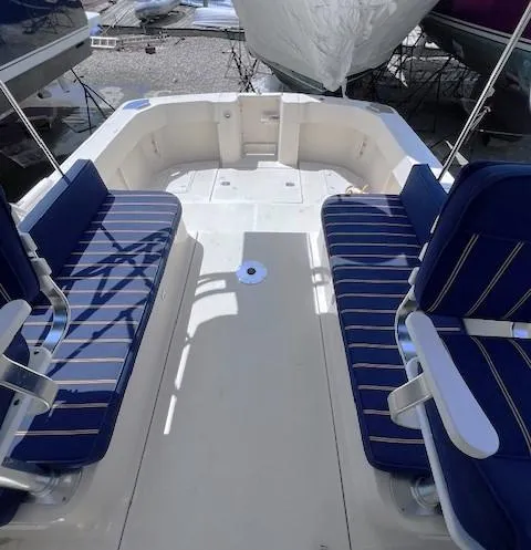 Slide: The Image of 2004 Mainship 30 Pilot Rum Runner boat with blue seating in the cockpit area. - 6