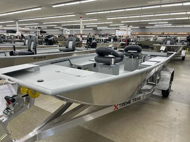 Slide: The Image of 2025 XTREME BOATS River Skiff 1548SS displayed in showroom, featuring sleek design and modern seating. - 5