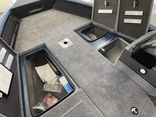 Slide: The Image of 2025 Ranger VS1782SC Angler boat interior with storage compartments and carpeted flooring. - 16