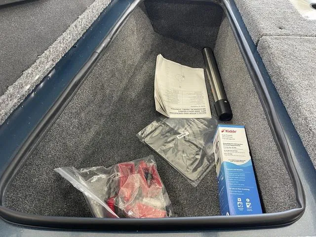 Slide: The Image of Storage compartment of 2025 Ranger VS1782SC Angler boat with accessories and manual. - 17