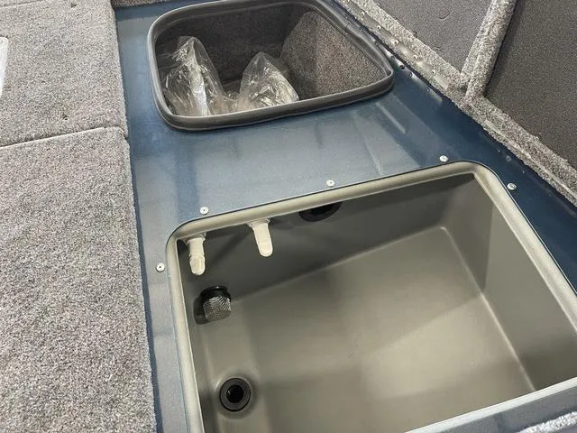 Slide: The Image of 2025 Ranger VS1782SC Angler boat storage compartments with carpeted interior. - 18