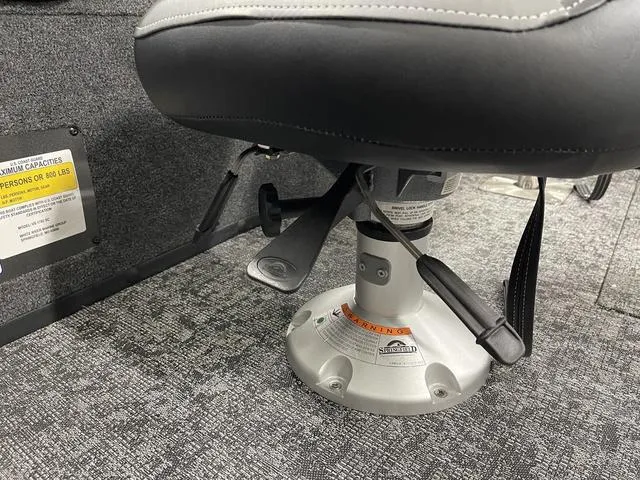 Slide: The Image of 2025 Ranger VS1782SC Angler boat seat with adjustable pedestal on carpeted floor. - 24