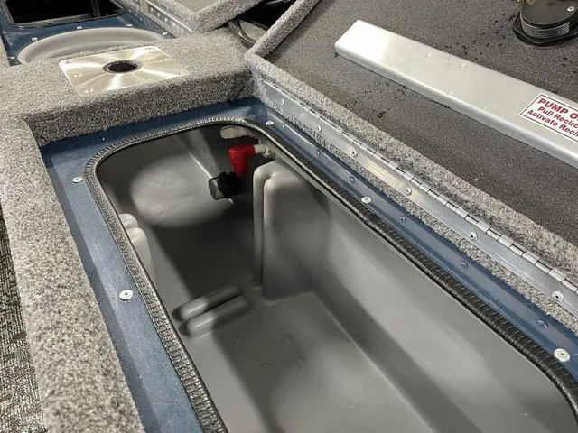 Slide: The Image of 2025 Ranger VS1782SC Angler boat storage compartment with gray interior and carpeted edges. - 32
