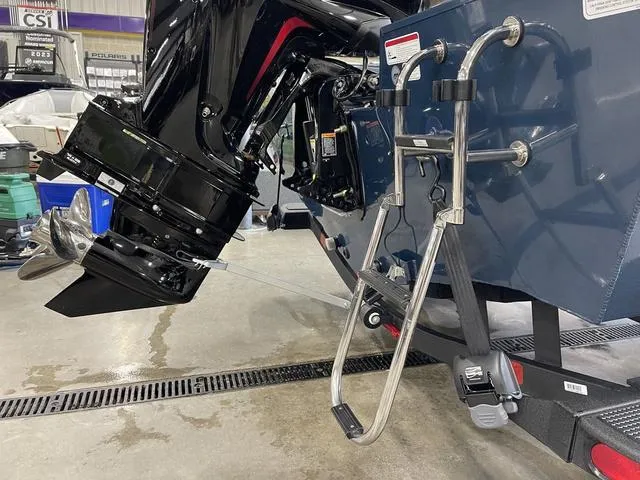 Slide: The Image of 2025 Ranger VS1782SC Angler boat with motor and ladder in a showroom. - 5