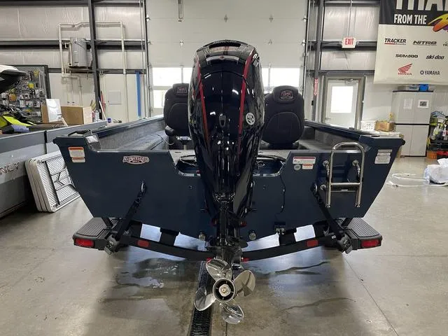 Slide: The Image of 2025 Ranger VS1782SC Angler boat in a garage, rear view with motor and ladder. - 6